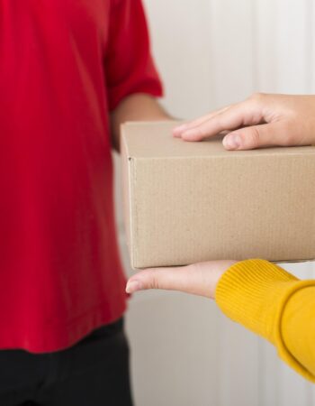 woman-taking-package-from-delivery-man